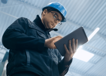 Building-worker-looking-down-at-digital-tablet
