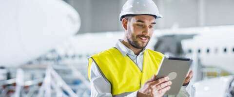 Building-worker-smiling-using-digital-tablet-1