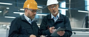 Building-workers-talking-looking-at-digital-tablet