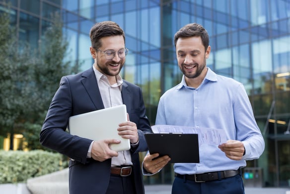 businessmen-discussing-documents-outside-office-bu-2026-09-24-23-27-06-utc