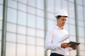 civil-engineer-reviews-plans-on-tablet-at-building-2026-09-22-03-13-51-utc