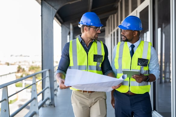 construction-engineers-reviewing-blueprints-on-wal-2026-09-23-02-16-22-utc