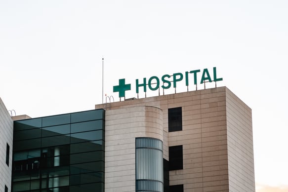 hospital-building-exterior-with-a-green-cross-sign-2026-09-23-23-53-09-utc