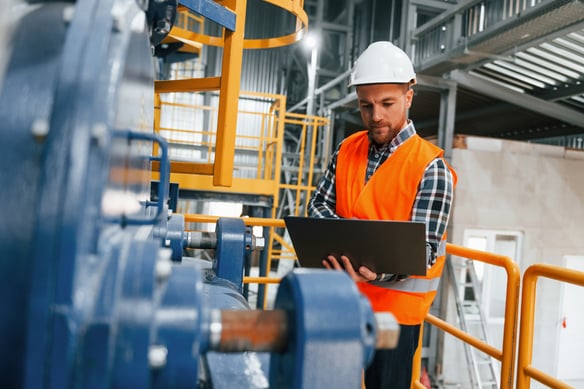 male-worker-using-laptop-at-industrial-plant-2026-09-24-05-43-39-utc