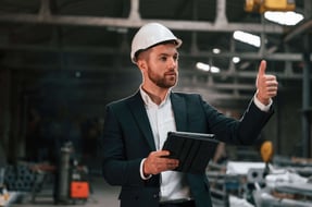 man-in-hardhat-with-tablet-gives-thumbs-up-2026-03-24-03-21-18-utc
