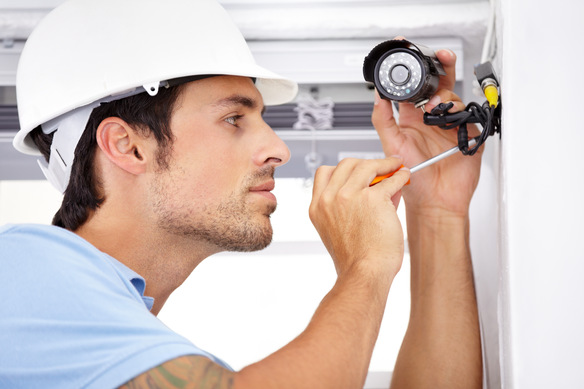 man-installing-security-camera-with-a-screwdriver-2026-09-22-05-36-21-utc