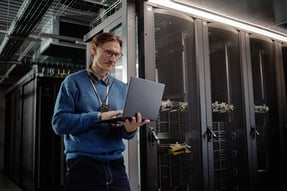 man-working-with-laptop-in-server-room-2026-09-25-02-14-00-utc