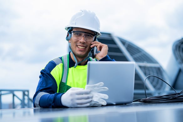 smiling-worker-on-phone-with-laptop-at-workplace-2026-09-24-23-25-46-utc