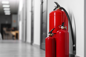 three-red-fire-extinguishers-in-a-modern-office-co-2026-09-25-04-00-51-utc
