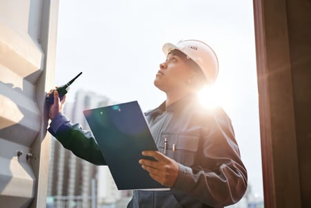 worker-inspecting-container-with-radio-at-daytime-2026-09-24-03-53-56-utc (1)