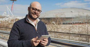 Man Smiling Using Tablet