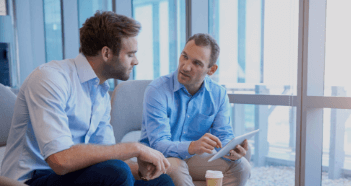 Two Men Talking Using Tablet