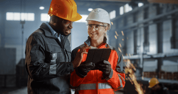 Man With Orange Hard Hat Using Tablet