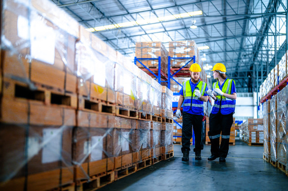 warehouse-workers-discussing-logistics-amid-high-p-2026-09-25-07-08-46-utc