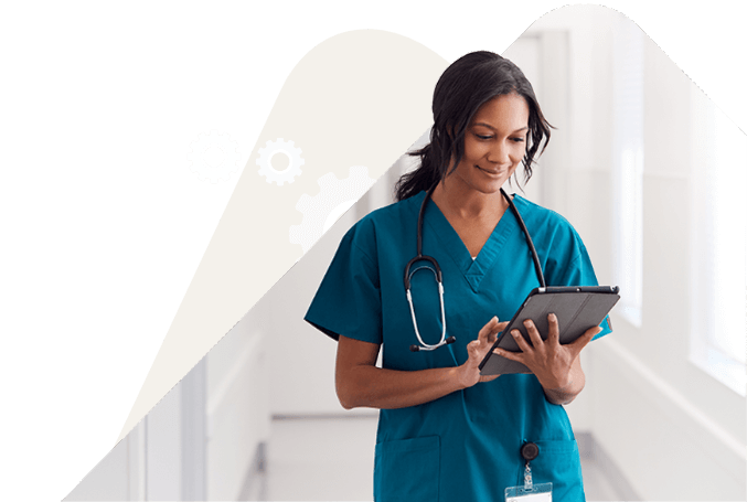 Doctor in blue scrubs reading an handheld device. Doctor in blue scrubs reading an handheld device.