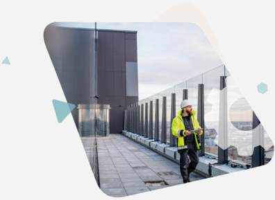 Man in high vis vest on top of a building