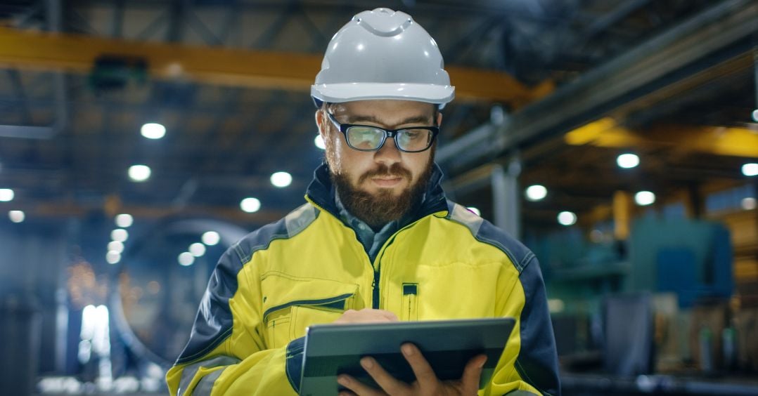 Building worker reading from an electronic tablet 
