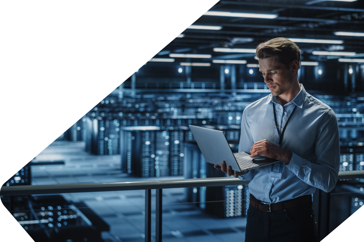 man-in-data-centre-on-laptop